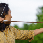 a woman with a bow and arrow