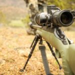 shallow focus photo of rifle with scope