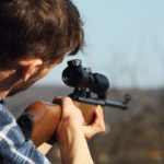 person using sniper rifle
