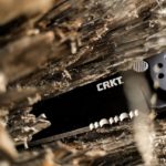 crkt knife attached to tree