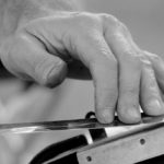man sharpening a knife craft job